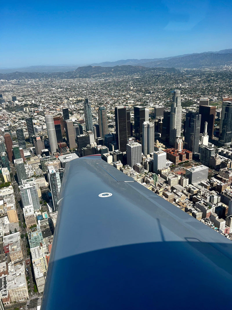 Small aircraft over the downtown Los Angeles skyline on a night flight from Van Nuys