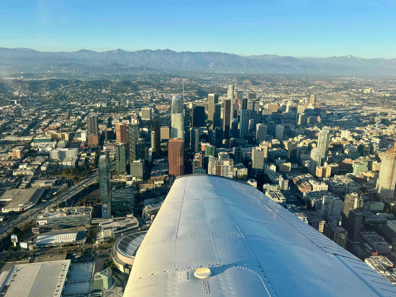 View over the wing of a training aircraft above Los Angeles on a clear afternoon