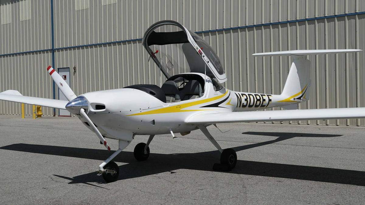 Diamond DA20-C1 on the ramp with its bubble canopy open over the two-seat cockpit