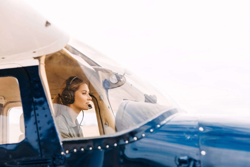 Instructor and student wearing headsets in the cockpit during a Part 61 training flight