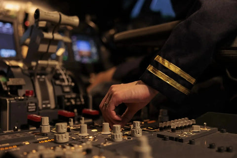 A pilot setting the throttle quadrant in a jet cockpit