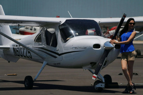 A student pilot beside the propeller of a Cessna 162 Skycatcher on the ramp